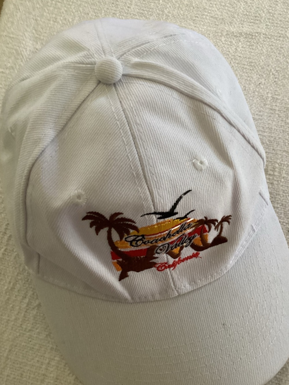 Coachella Valley souvenir baseball cap with an embroidered sunset and palm tree